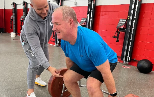 Man working out with coach